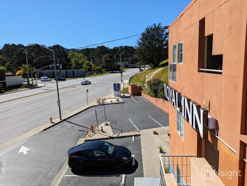 a car parked in a parking lot next to a building at Royal Inn in South San Francisco