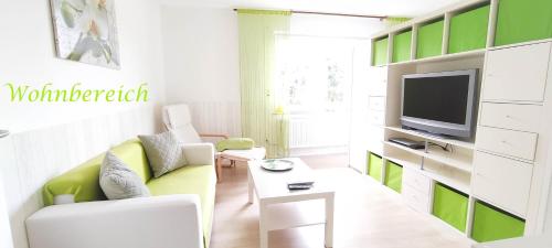 a living room with a couch and a tv at Ferienwohnung Pagel in Riedenburg