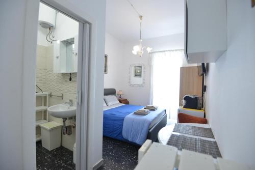 a bedroom with a bed and a sink and a mirror at B&B CASAVACANZE CHIESA MADRE in Carovigno