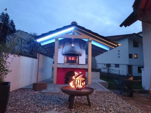 a fire pit with a stove in a backyard at Ferienwohnung Felsenblick in Albstadt