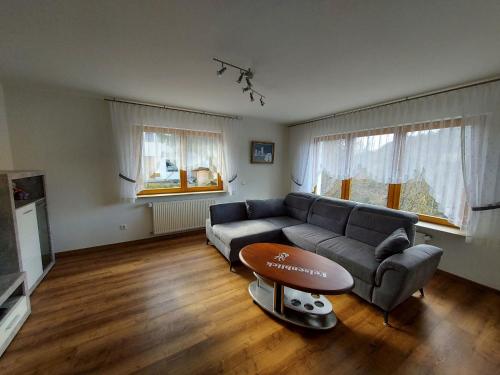 a living room with a couch and a table at Ferienwohnung Felsenblick in Albstadt