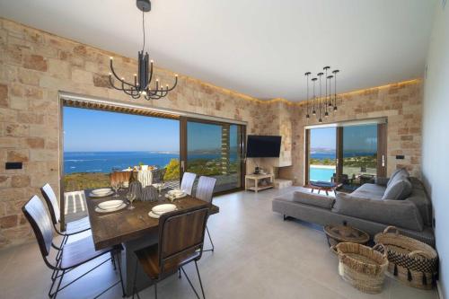 a living room with a dining table and a couch at Narcissos Villa in Argostoli