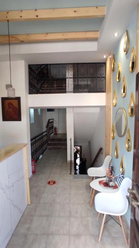 a living room with white chairs and a table at House Mistral in Neos Marmaras