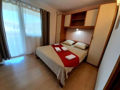 a bedroom with a bed with two towels on it at Tea-Dream house in Cesarica