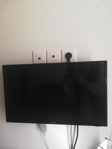 a flat screen tv hanging on a wall at COUP DE COEUR Studio in Rivedoux-Plage