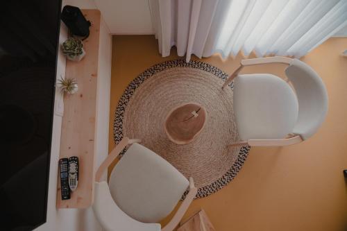 a room with two chairs and a hat on the wall at Casinhas de Santo António in Alter do Chão