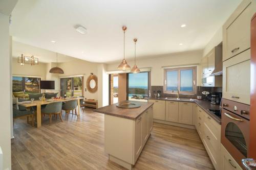 a large kitchen with a table and a dining room at Echos Villa in Argostoli