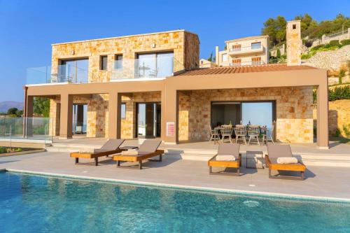 a villa with a swimming pool in front of a house at Echos Villa in Argostoli