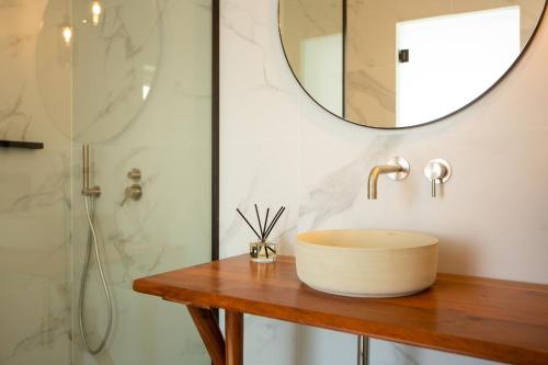 a bathroom with a sink and a shower at Eleana Hotel in Tinos Town