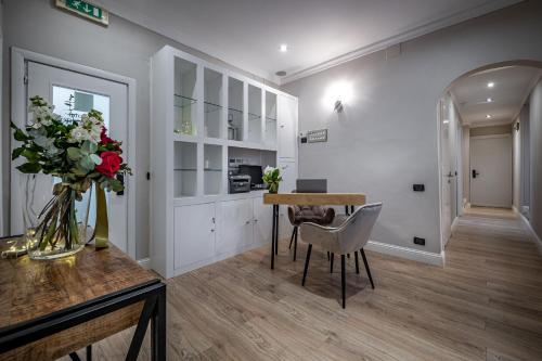 a living room with a table and chairs and a kitchen at Boutique Hotel Borgo in Florence