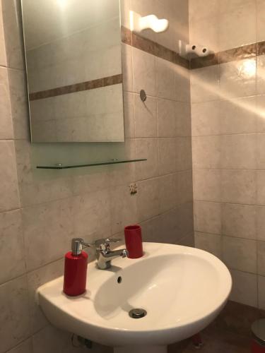 a bathroom with a white sink and a mirror at The salty studio in Rethymno