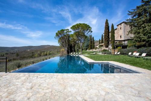 an infinity pool in the backyard of a villa at Castello di Spaltenna Exclusive Resort & Spa in Gaiole in Chianti