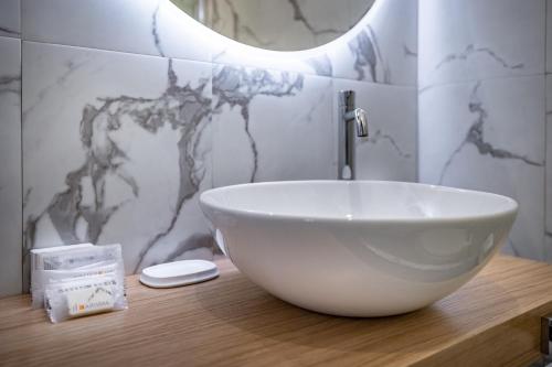 a bathroom with a bowl sink on a wooden counter at Boutique Hotel Borgo in Florence