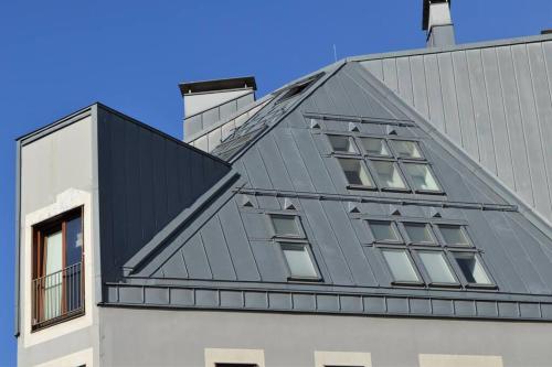 a building with a gray roof with windows at Luxury apartment with a balcony and view in Riga Old Town in Rīga