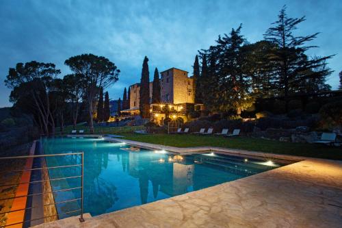 a large swimming pool in front of a building at Castello di Spaltenna Exclusive Resort & Spa in Gaiole in Chianti