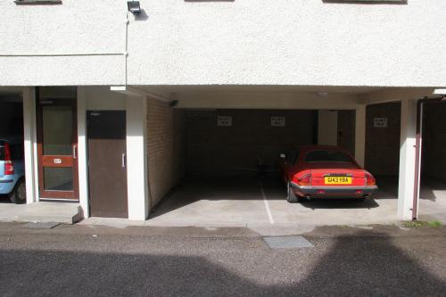 a red car parked inside of a garage at Howgill in Windermere