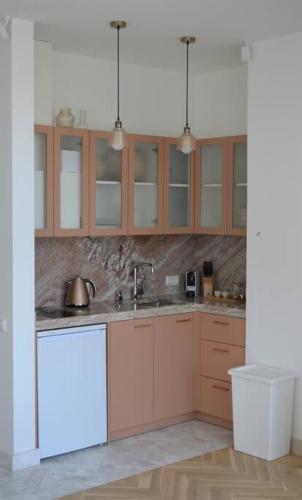 a kitchen with wooden cabinets and a sink at Luxury apartment with a balcony and view in Riga Old Town in Riga