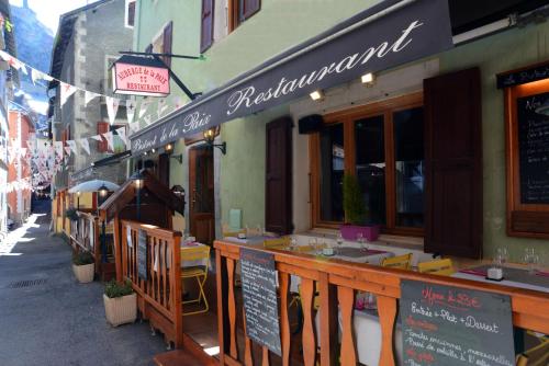 a restaurant with a bar on the side of a street at Auberge de la Paix in Briançon