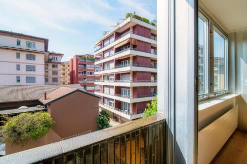 an apartment balcony with a view of a building at Palace Apartment by Quokka 360 - 2 minutes from Lugano Lido in Lugano