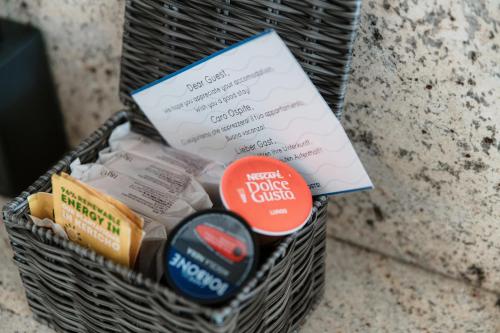 a basket filled with food and a piece of paper at Palace Apartment by Quokka 360 - 2 minutes from Lugano Lido in Lugano