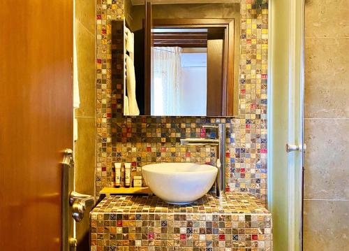 a bathroom with a sink and a mirror at Nassamat Boutique Hotel in Al Bārūk