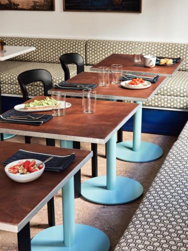 a table in a restaurant with plates of food on it at Hôtel Rosalie in Paris