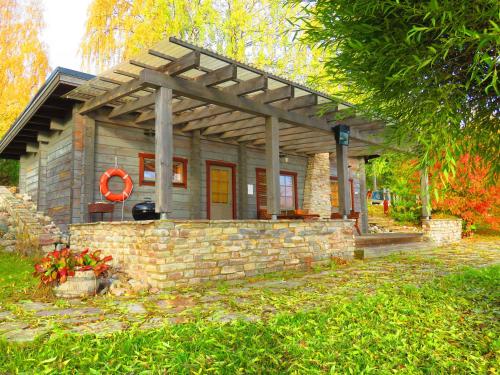 a small stone house with a stone wall at Holiday Village Tahko-Tours in Tahkovuori