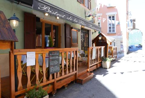 a restaurant with a sign on the front of a building at Auberge de la Paix in Briançon