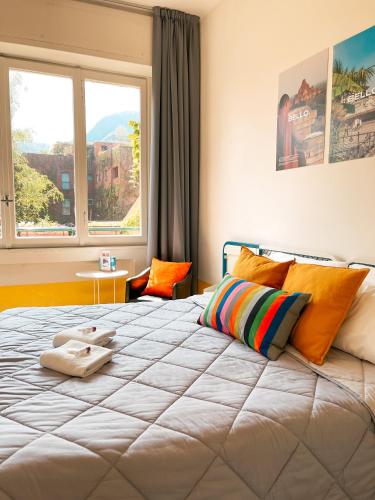 a bedroom with a large bed with a large window at Ostello Bello Lake Como in Como
