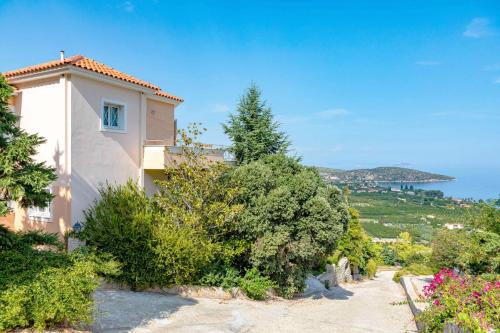 a house on a hill with a view of the ocean at Epidavros Land villa Elia in Ancient Epidavros