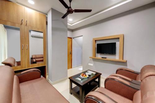 a living room with chairs and a flat screen tv at Click Hotel Guwahati in Guwahati