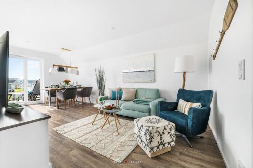 a living room with a blue couch and a table at FeWo Olpenitz in Olpenitz