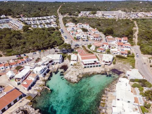 an aerial view of a town with blue water at Biniancolla Ginesta in Biniancolla
