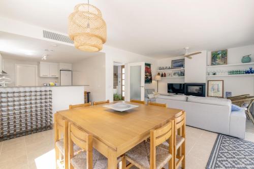 a dining room and living room with a table and chairs at Biniancolla Ginesta in Biniancolla