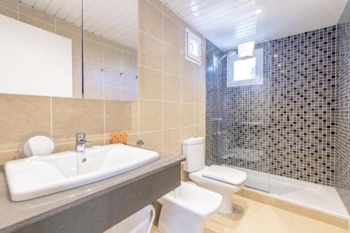 a bathroom with a sink and a toilet and a shower at Biniancolla Ginesta in Biniancolla