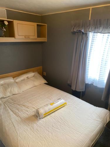 a bedroom with a bed with a thermometer on it at 187 sealands in Ingoldmells