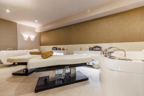 a hospital room with two beds and two sinks at Olymp IV in Kołobrzeg
