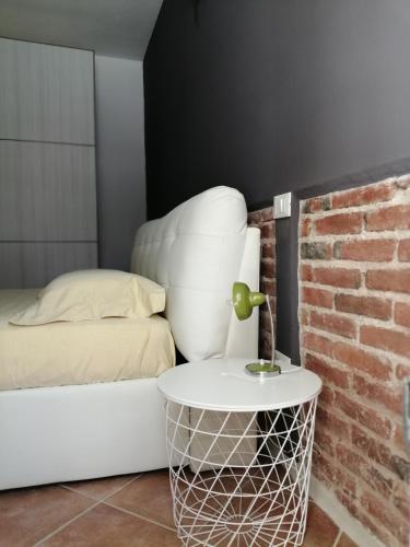 a bedroom with a bed and a white chair at Casa Saba in Orosei