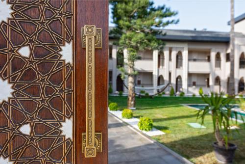 a wooden post in front of a building at Alaaddin Beach Hotel - Adult Only in Alanya