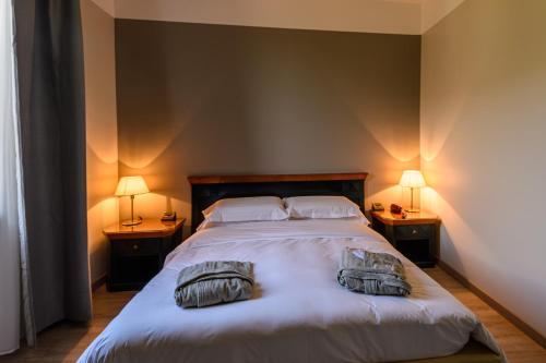 a bedroom with a bed with two pillows on it at Villa Kinzica in Sale Marasino