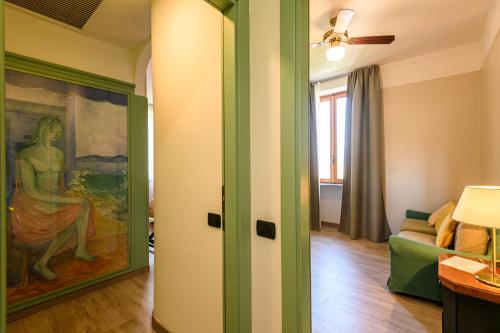 a living room with a painting on the wall at Villa Kinzica in Sale Marasino
