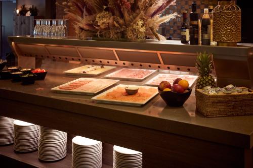 a buffet of food on a counter in a restaurant at Van der Valk Hotel Dennenhof in Brasschaat