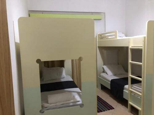 a small room with two bunk beds in it at Genci Seaview Apartaments@AlbaResidence in Sarandë