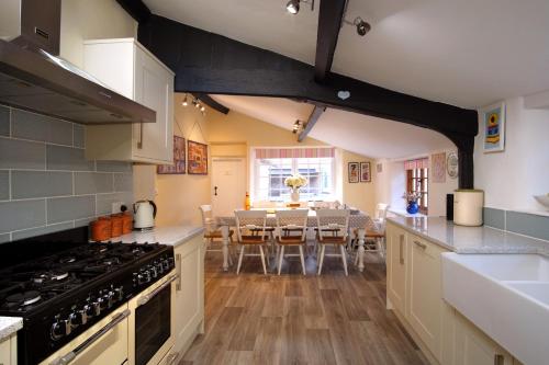 a kitchen with a table and a dining room at The Old Sweet Shop in Minehead