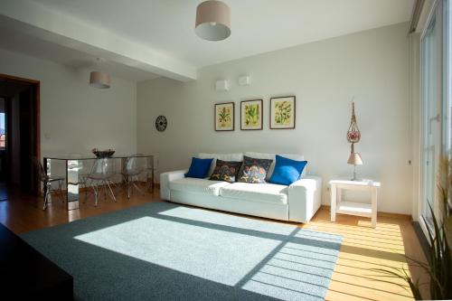 a living room with a white couch and a table at Downtown PDL in Ponta Delgada
