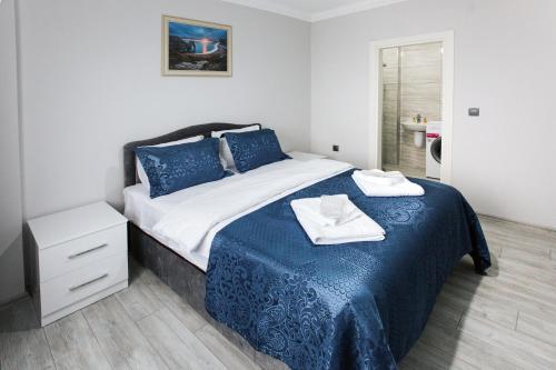 a bedroom with a bed with blue sheets and towels on it at Melissa Suite Otel in Trabzon