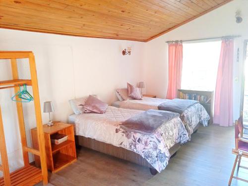 a bedroom with two beds and a window at Rheola's Guest Cottage in Harrismith