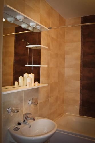 a bathroom with a sink and a mirror and a tub at Villa Malina Luštica in Tivat