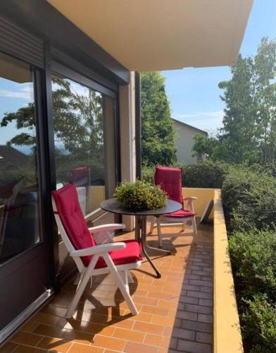 a patio with three chairs and a table on a balcony at Exklusives Apartment in Bad Säckingen für 2 Person in Bad Säckingen