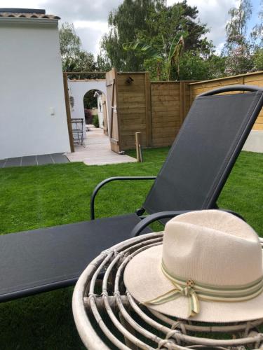 a hat sitting on a table in a yard at Chambre Cosy Chic in Challans
